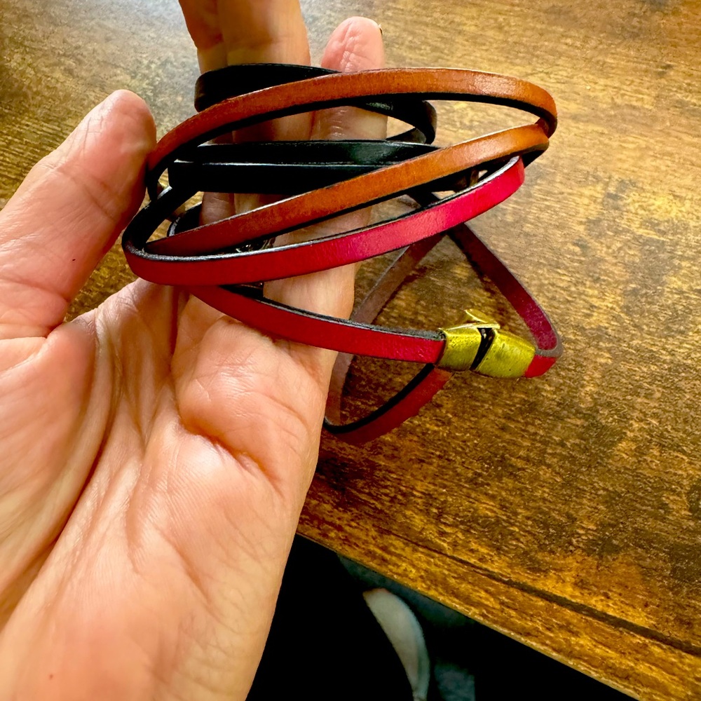 Handmade leather bracelets with gold clasps.